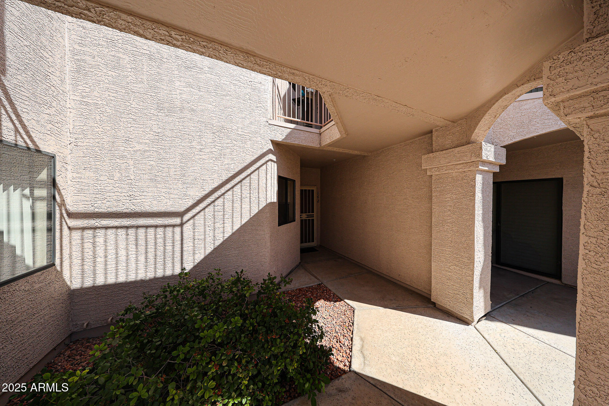 9151 West Greenway Road, Unit 162 Peoria, AZ 85381 - Photo 5 of 37 a view of staircase with wooden floor and wall