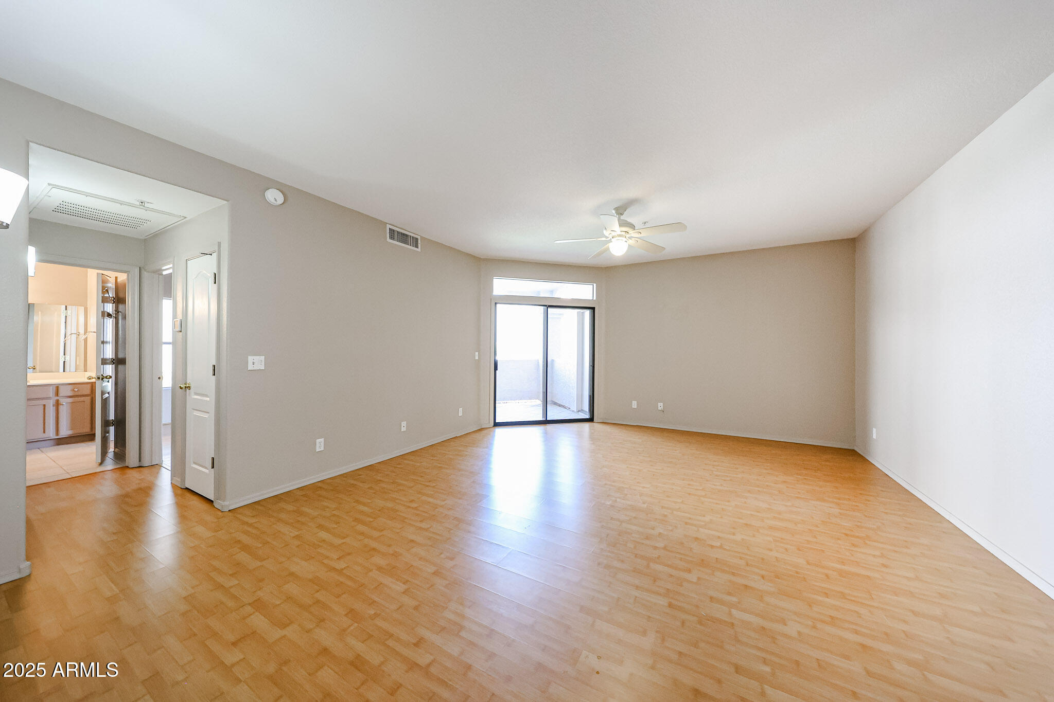 9151 West Greenway Road, Unit 162 Peoria, AZ 85381 - Photo 10 of 37 a view of empty room with wooden floor and windows