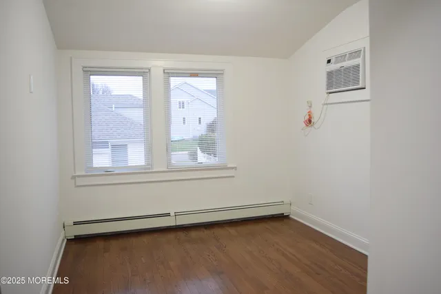 a view of a small space with wooden floor and a window