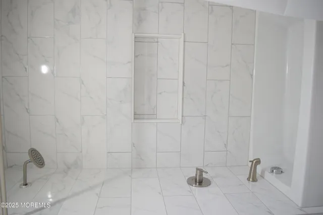 a kitchen with granite countertop a stove a sink dishwasher and a refrigerator with wooden floor