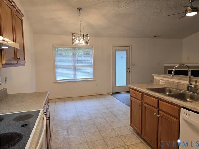 a view of a kitchen with a sink and dishwasher