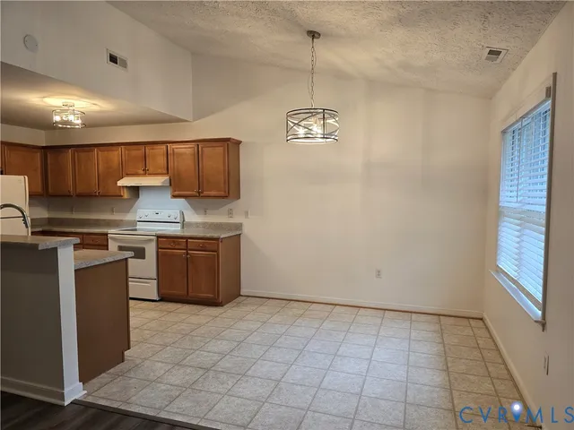 a kitchen with granite countertop a sink cabinets and stainless steel appliances