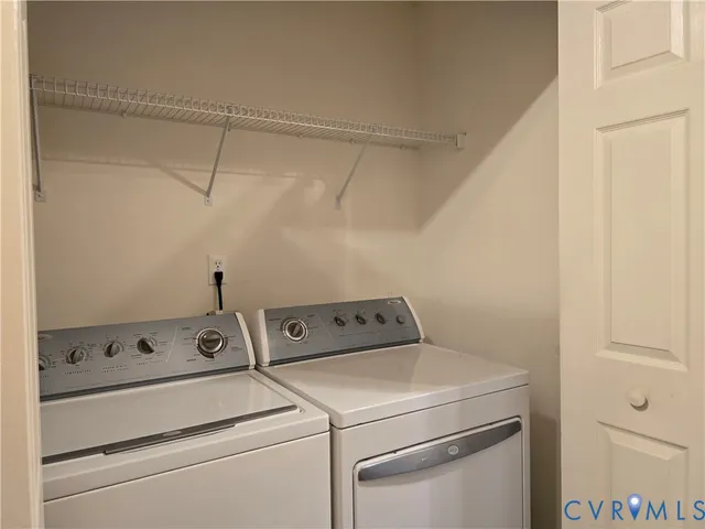 a view of a storage and utility room with washer and dryer