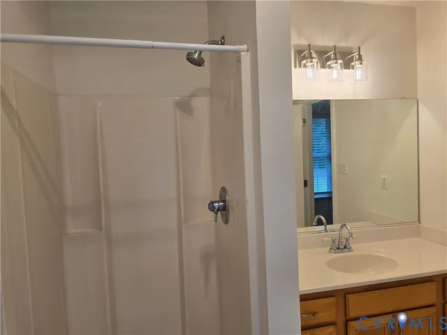 a bathroom with a shower and a sink