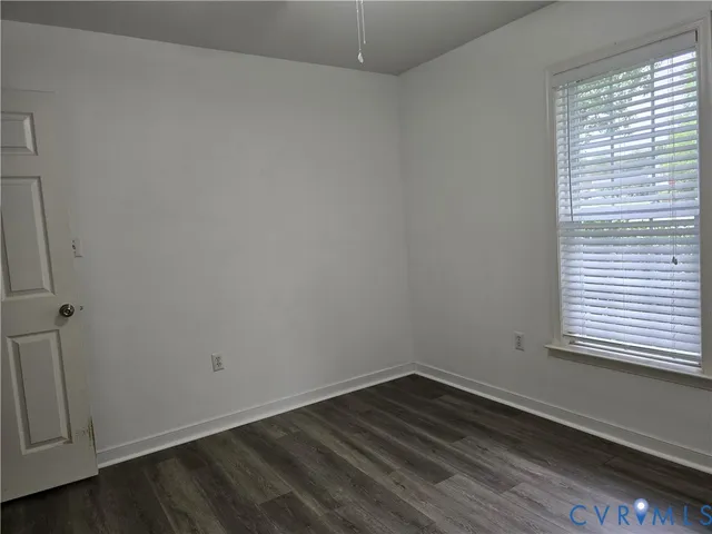 a view of a room that has wooden floor and window