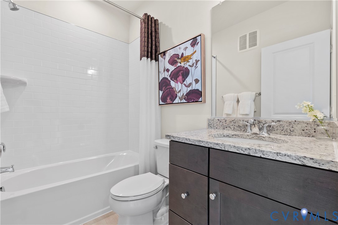 3611 Edna Path, Unit A Richmond, VA 23233 - Photo 22 of 32 a bathroom with a granite countertop sink a toilet and a bathtub