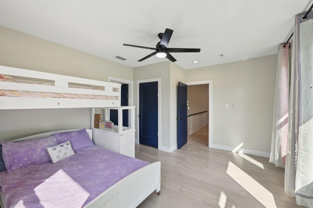 702 Griffith Avenue Terrell, TX 75160 - Photo 33 of 40 a bedroom with a large bed and a chandelier