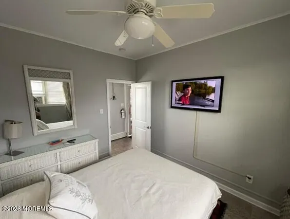 a bedroom with a large bed and a flat screen tv