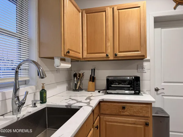 a kitchen with granite countertop a sink and cabinets