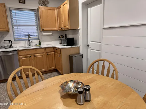 a kitchen with a sink a stove and cabinets