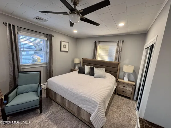 a bedroom with a bed couch and a window