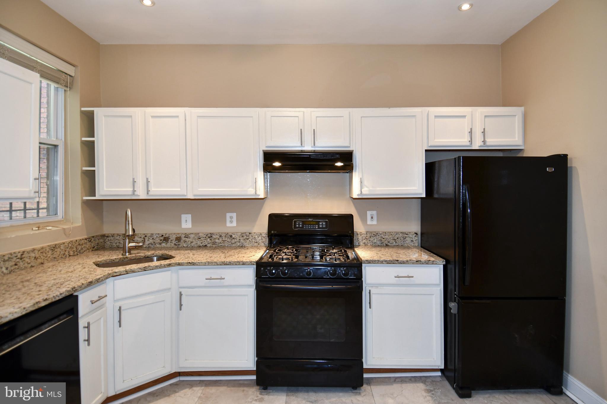 11 R Street Northwest Washington, DC 20001 - Photo 15 of 55 a kitchen with a sink and a stove