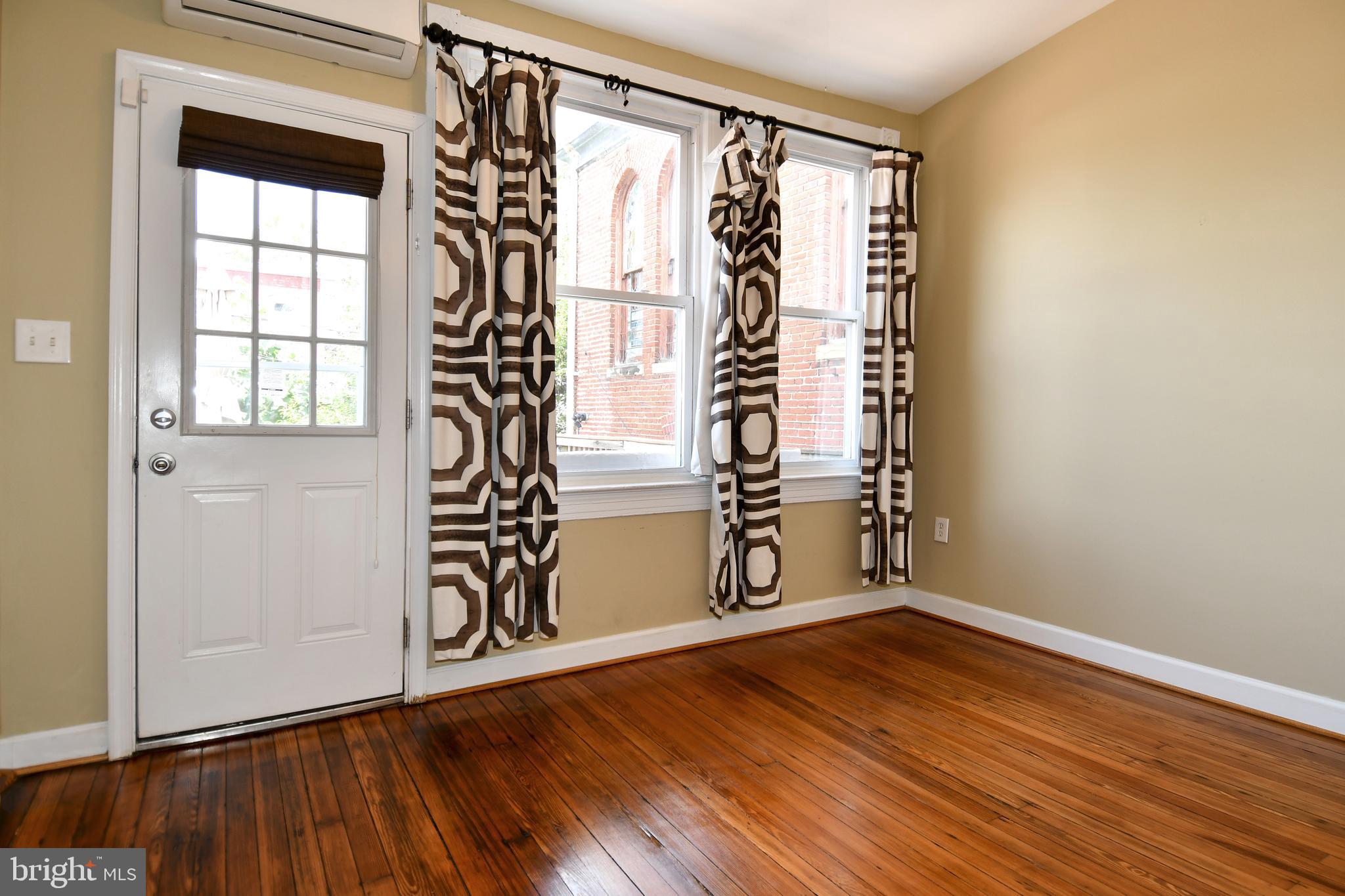 11 R Street Northwest Washington, DC 20001 - Photo 19 of 55 an empty room with wooden floor and windows