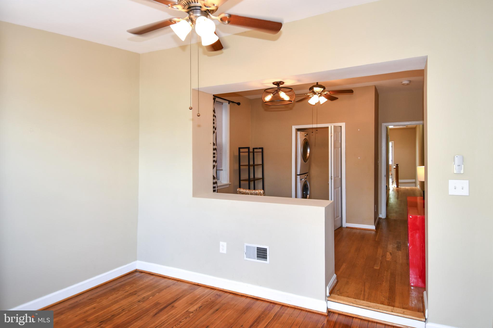11 R Street Northwest Washington, DC 20001 - Photo 22 of 55 a view of a hallway with wooden floor and chandelier