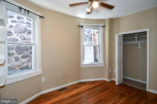 a view of a livingroom with wooden floor and a fireplace