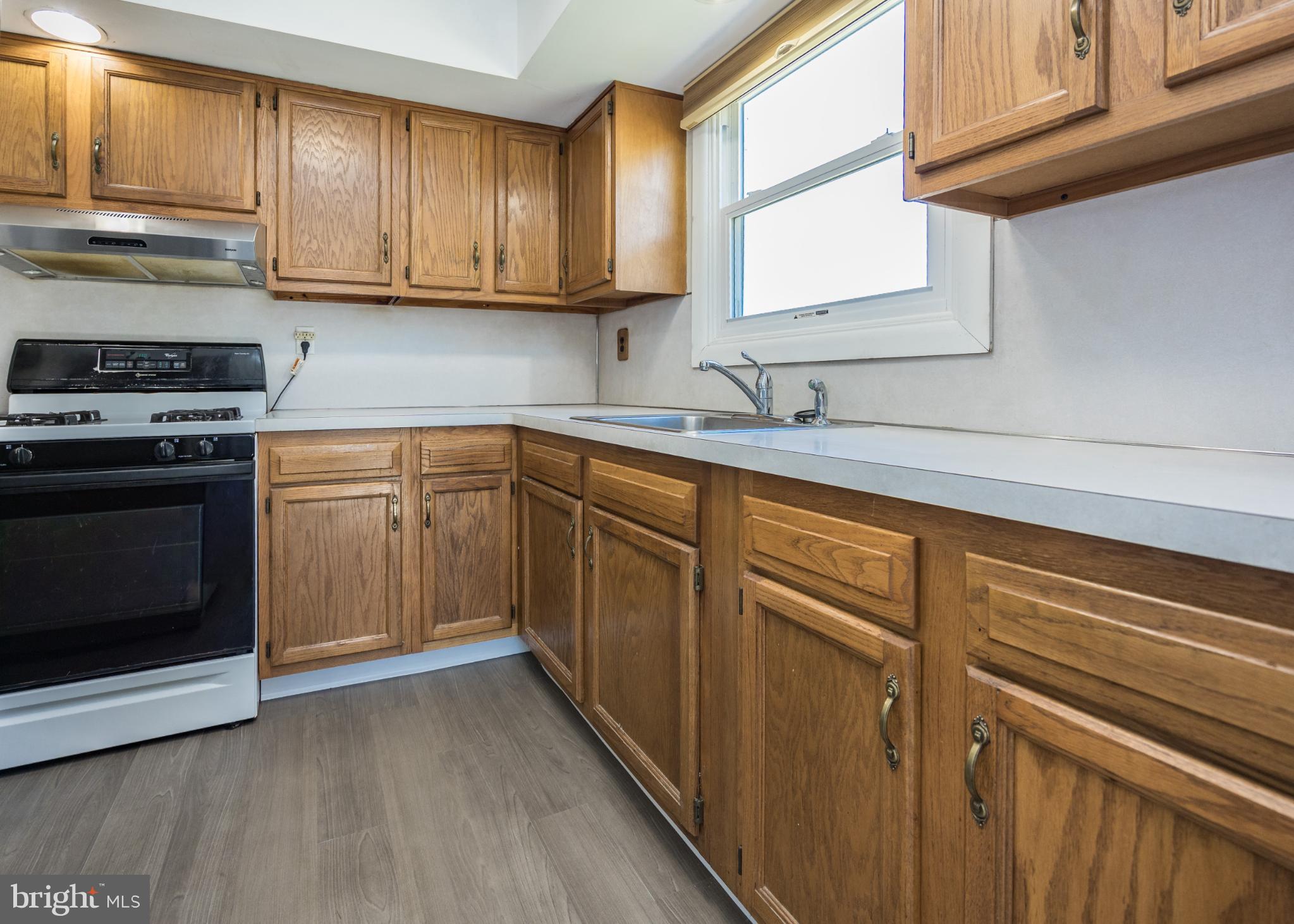 14 Lasalle Avenue New Castle, DE 19720 - Photo 8 of 23 a kitchen with cabinets appliances a sink and a window