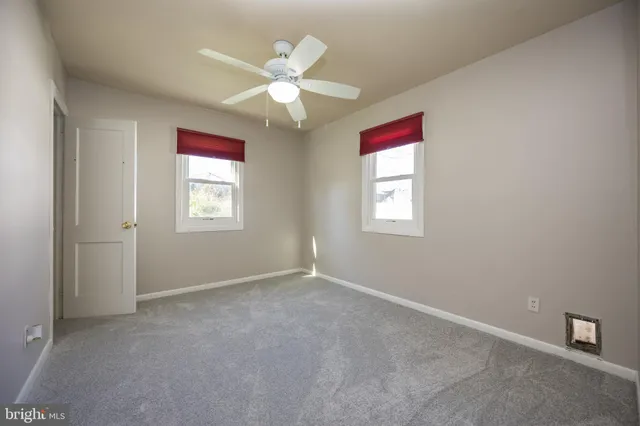 a view of a refrigerator and window in a kitchen