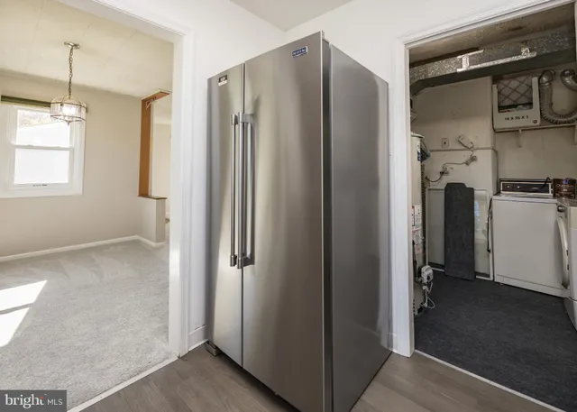a kitchen with granite countertop cabinets stainless steel appliances and a counter space