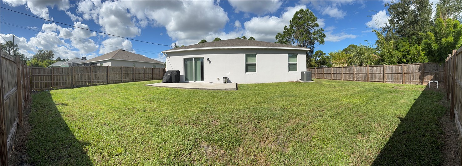 8166 97th Avenue Vero Beach, FL 32967 - Photo 2 of 11 a view of a house with backyard and a garden