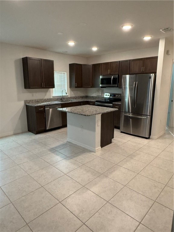 8166 97th Avenue Vero Beach, FL 32967 - Photo 3 of 11 a large kitchen with a large counter top stainless steel appliances and cabinets