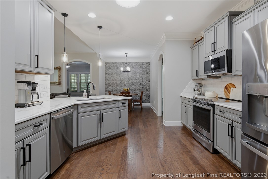 148 Heatherspring Way Spring Lake, NC 28390 - Photo 22 of 50 a large kitchen with cabinets wooden floor and stainless steel appliances
