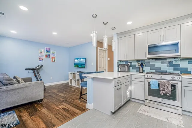 a kitchen with kitchen island granite countertop a sink cabinets and window