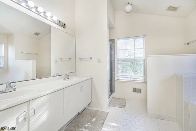 a spacious bathroom with a double vanity sink mirror and
