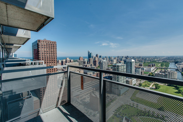 235 West Van Buren Street, Unit 4111 Chicago, IL 60607 - Photo 15 of 15 a city view from a balcony with chairs