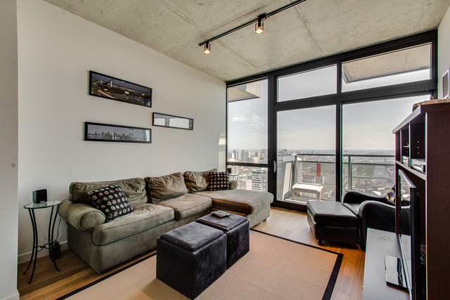 235 West Van Buren Street, Unit 4111 Chicago, IL 60607 - Photo 4 of 15 a living room with furniture and a floor to ceiling window