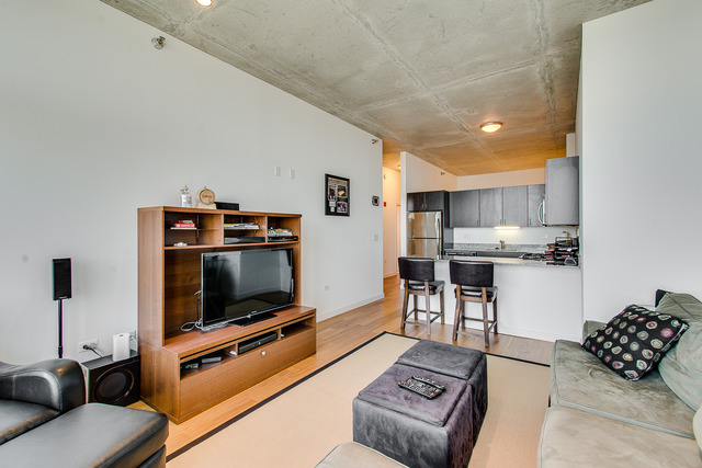 235 West Van Buren Street, Unit 4111 Chicago, IL 60607 - Photo 6 of 15 a living room with furniture and a flat screen tv