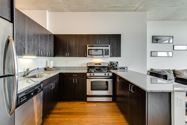 235 West Van Buren Street, Unit 4111 Chicago, IL 60607 - Photo 7 of 15 a kitchen with a sink stove and refrigerator