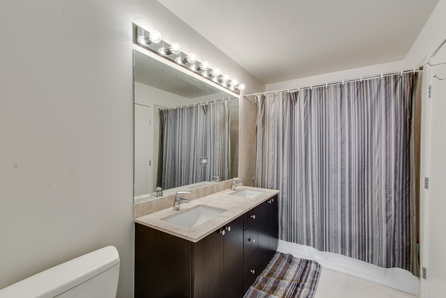 235 West Van Buren Street, Unit 4111 Chicago, IL 60607 - Photo 10 of 15 a bathroom with a sink and a mirror