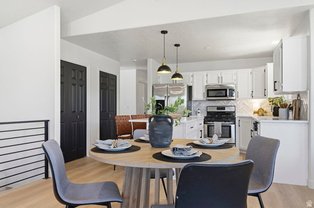 2460 Allison Way Syracuse, UT 84075 - Photo 9 of 24 Open-concept dining area featuring wood-finish flooring