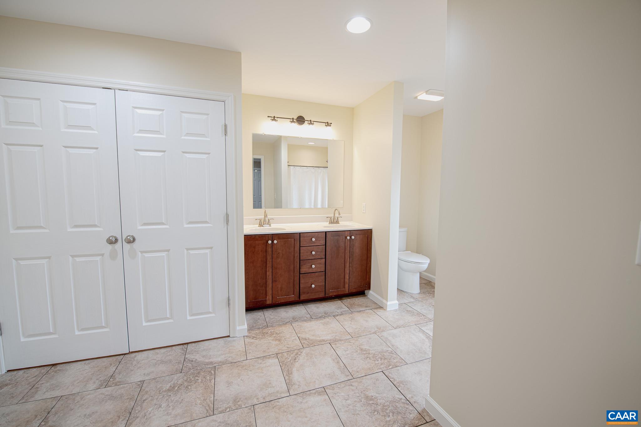 1101 Keith Road Stanardsville, VA 22973 - Photo 13 of 38 a bathroom with a tub shower vanity and a sink