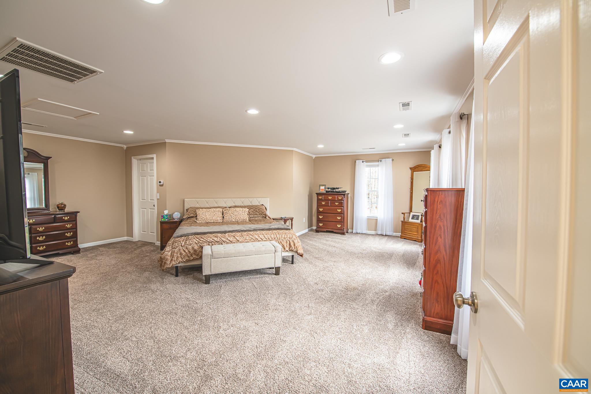 1101 Keith Road Stanardsville, VA 22973 - Photo 9 of 38 a spacious bedroom with a bed and a couch