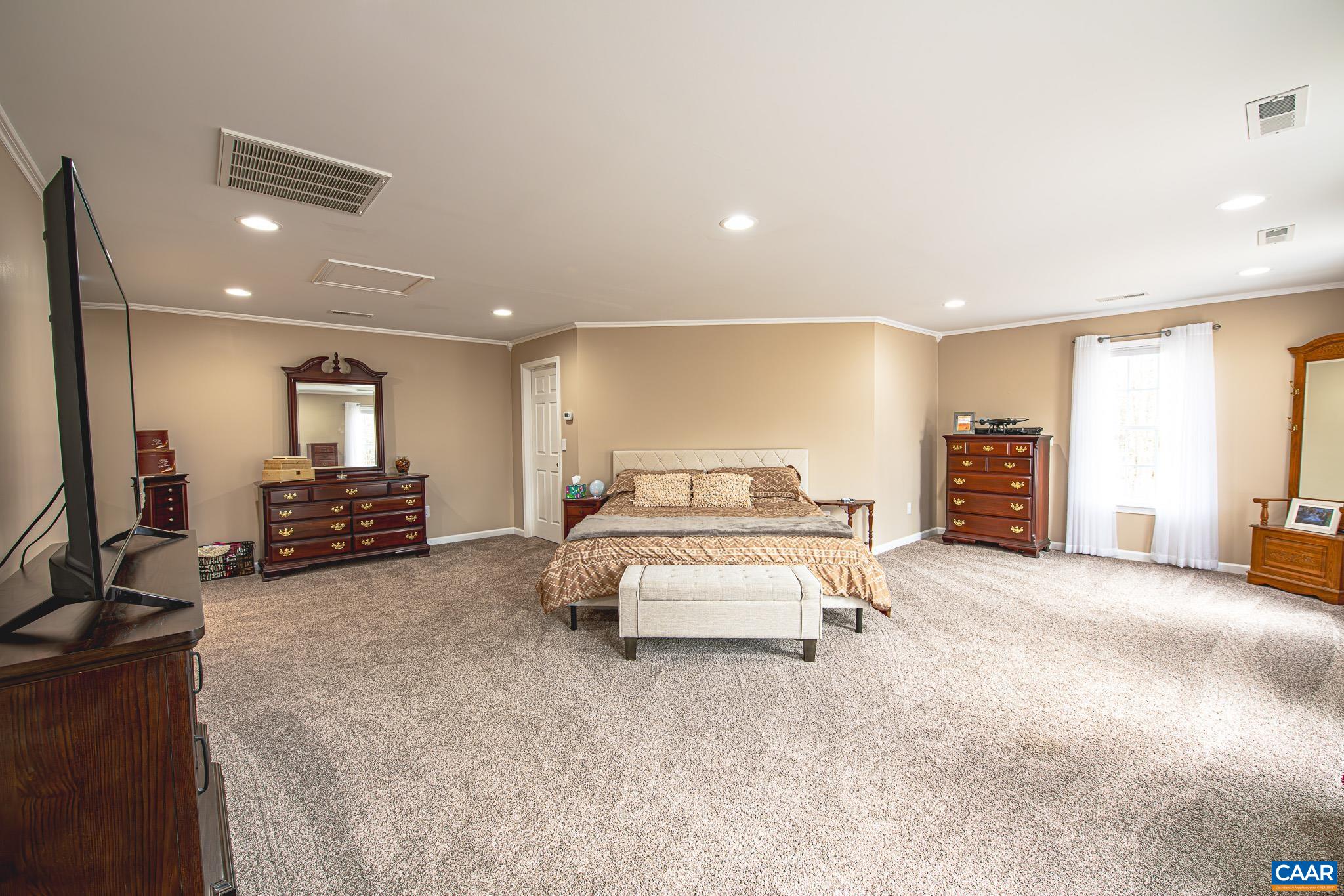 1101 Keith Road Stanardsville, VA 22973 - Photo 10 of 38 a large bedroom with a bed and a large window