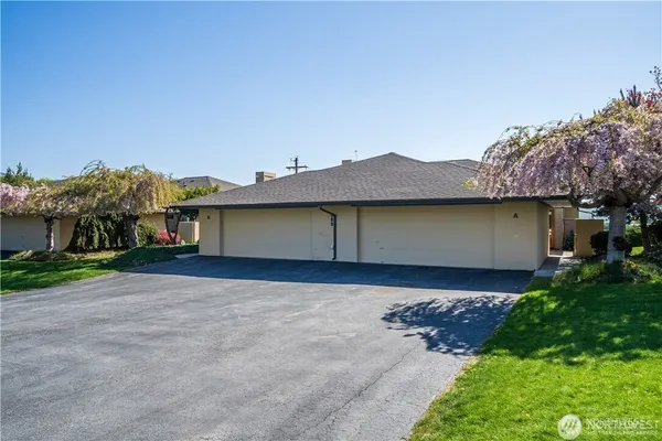 a view of a house with a yard and garage