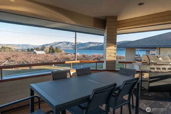 a dining room with furniture and a floor to ceiling window