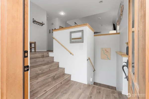 a view of entryway with wooden floor and stairs