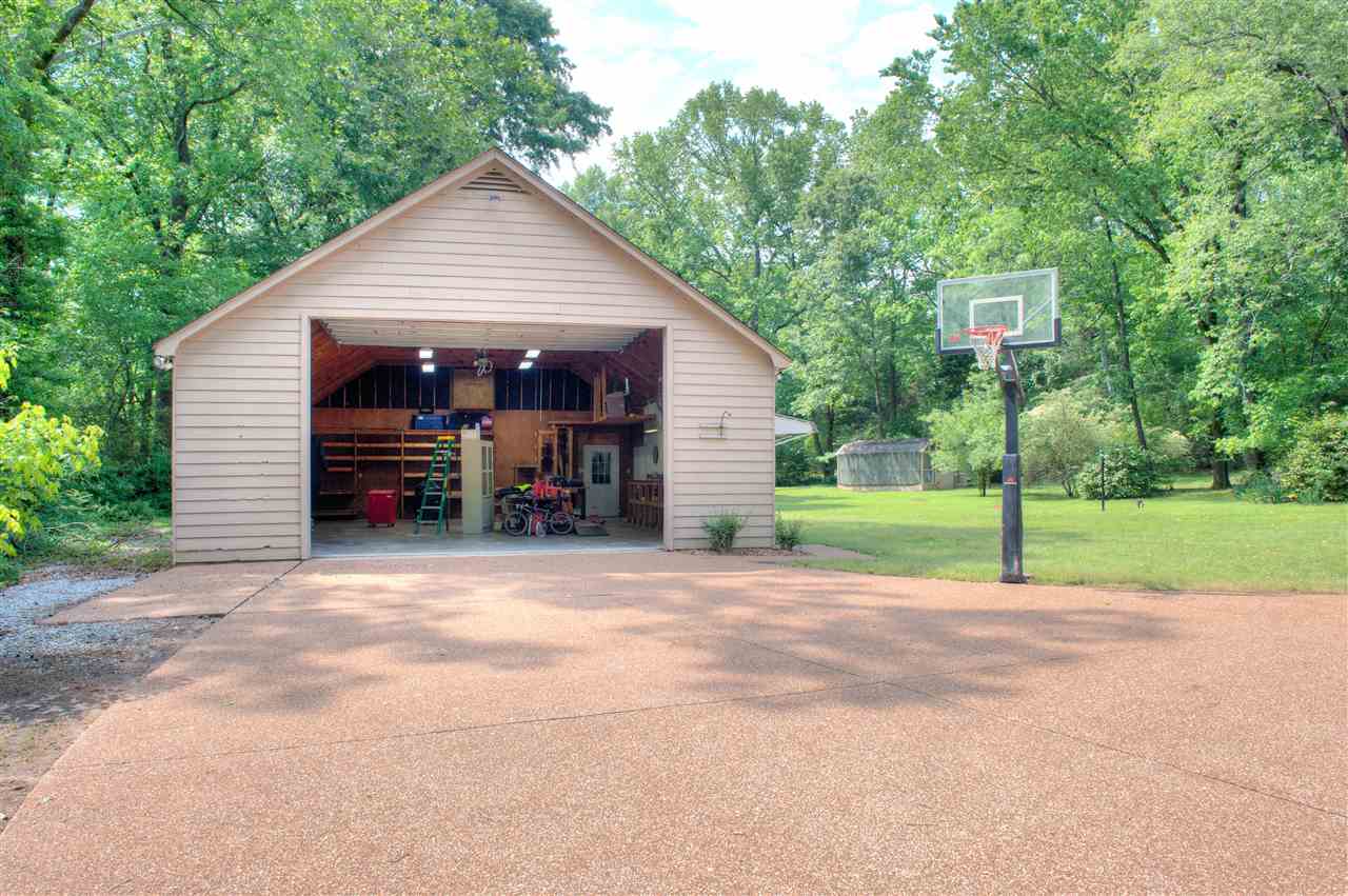 6165 Brunswick Road Arlington, TN 38002 - Photo 22 of 25 12 ft Garage Door Entry into this amazing space with built-in workbench, extensive built-in shelving, industrial lighting, heaters and fans, utility sink and pegboard walls. Just THINK of the possibilities in this building! PLUS a 2nd Double Garage!