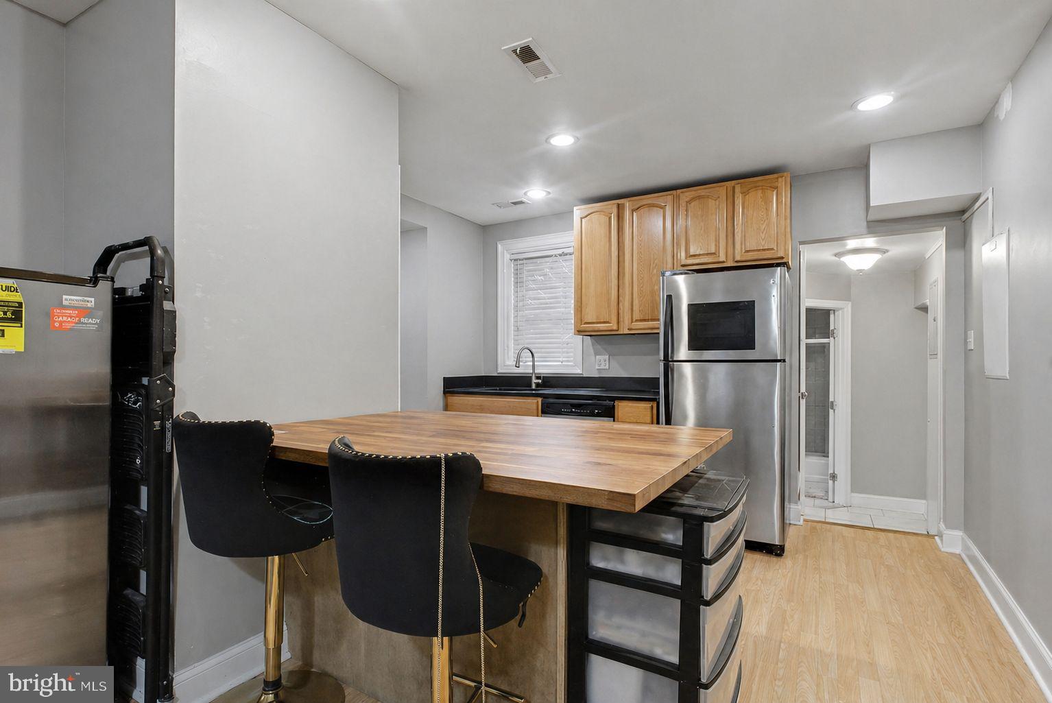 1936 North 7th Street, Unit 2 Philadelphia, PA 19122 - Photo 4 of 12 a kitchen with stainless steel appliances a table and chairs in it