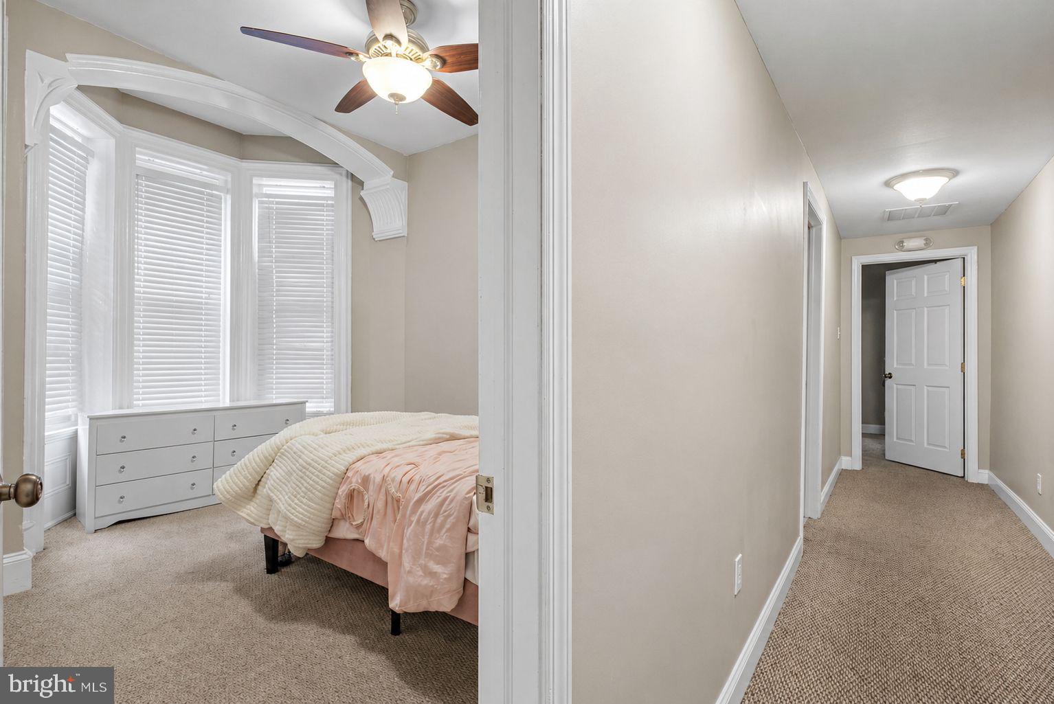 1936 North 7th Street, Unit 2 Philadelphia, PA 19122 - Photo 8 of 12 a bed room with a bed and a chandelier