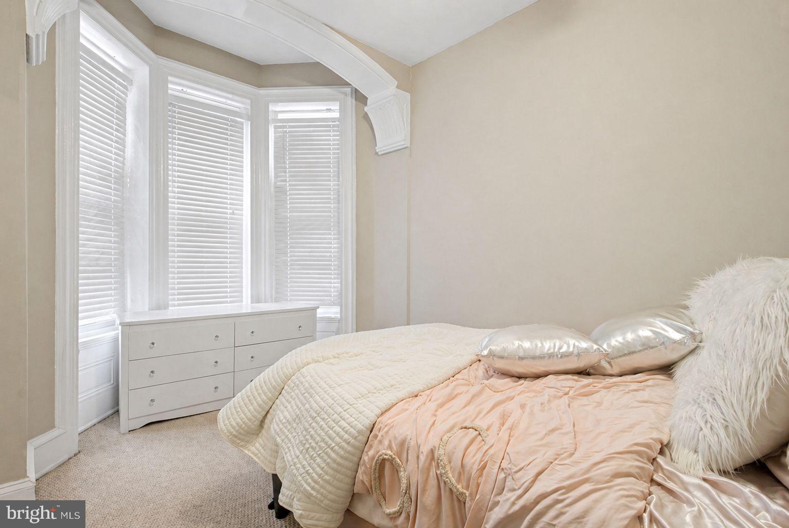 1936 North 7th Street, Unit 2 Philadelphia, PA 19122 - Photo 9 of 12 a bedroom with a bed and a window