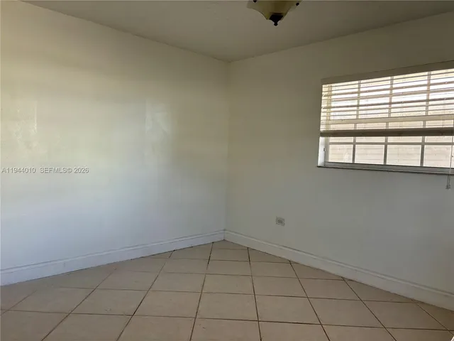 a view of a brick house with a large window