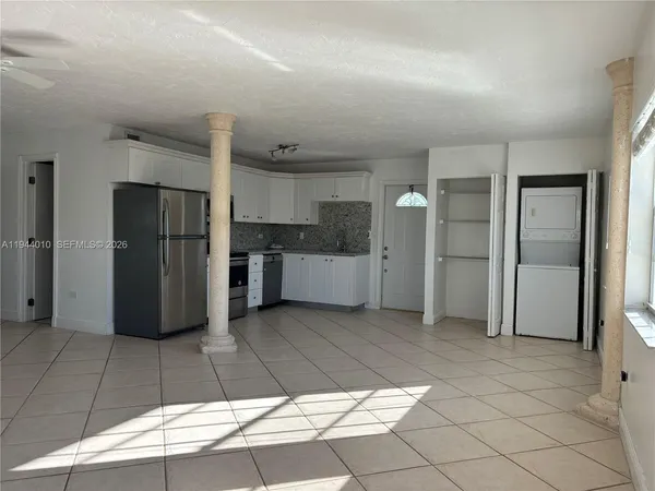 a view of an empty room and closet area
