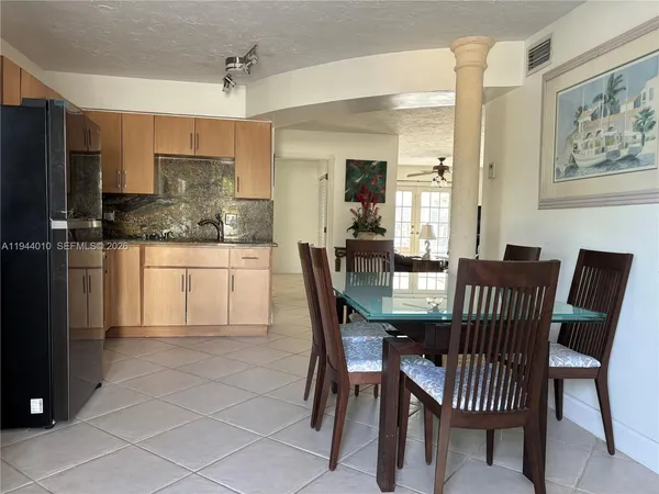 a kitchen with stainless steel appliances granite countertop a refrigerator and a stove