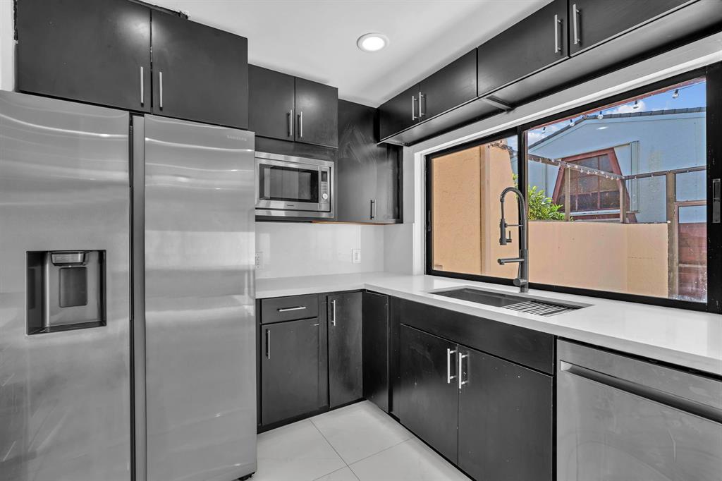 3896 Meadow Lane Hollywood, FL 33021 - Photo 14 of 33 a kitchen with stainless steel appliances granite countertop a refrigerator and a sink