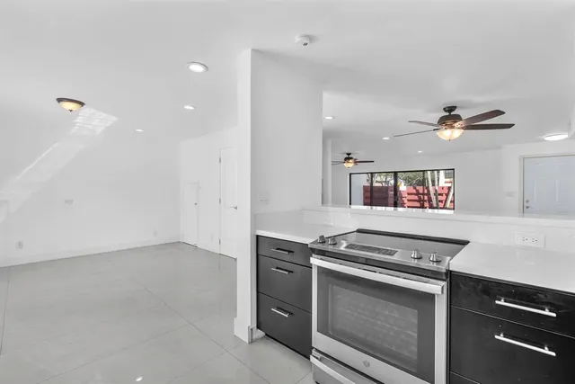 a kitchen with stainless steel appliances granite countertop a stove and a sink