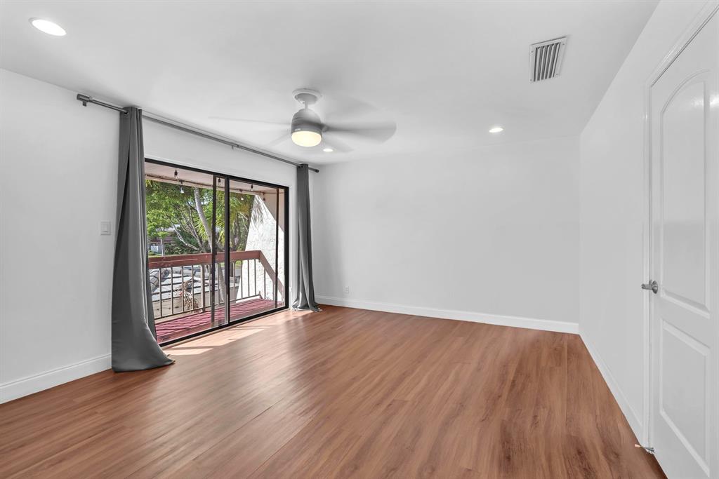 3896 Meadow Lane Hollywood, FL 33021 - Photo 23 of 33 a view of an empty room with wooden floor and a window