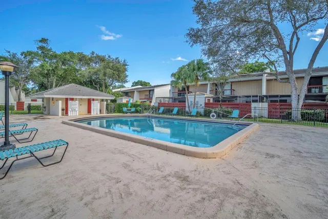 a view of a house with swimming pool and sitting area